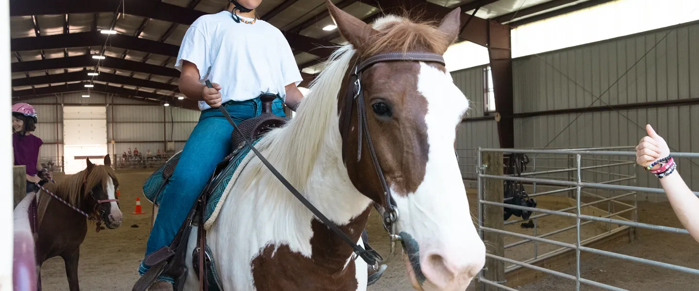 A boy on a horse at Camp 