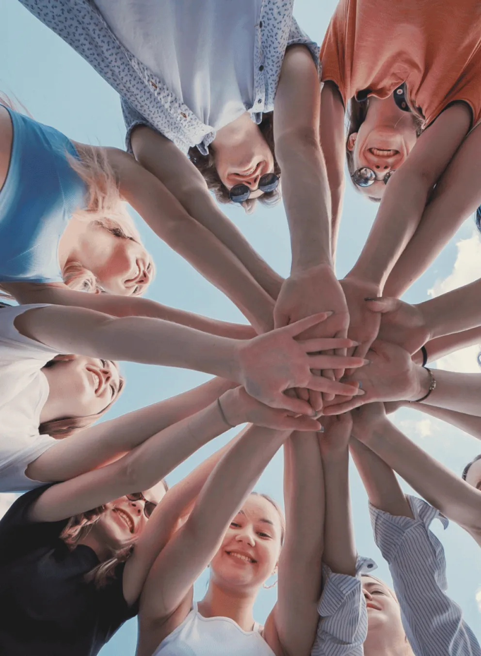 A group of people with their hands in together