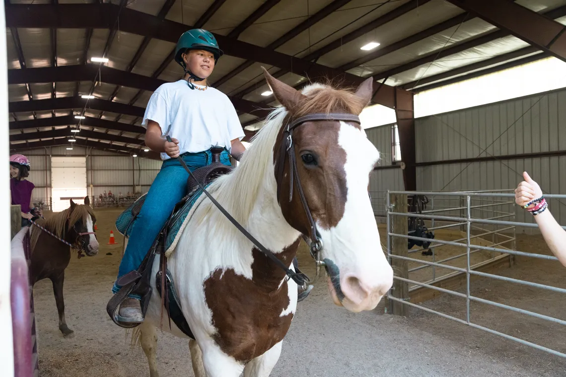A boy on a horse at Camp